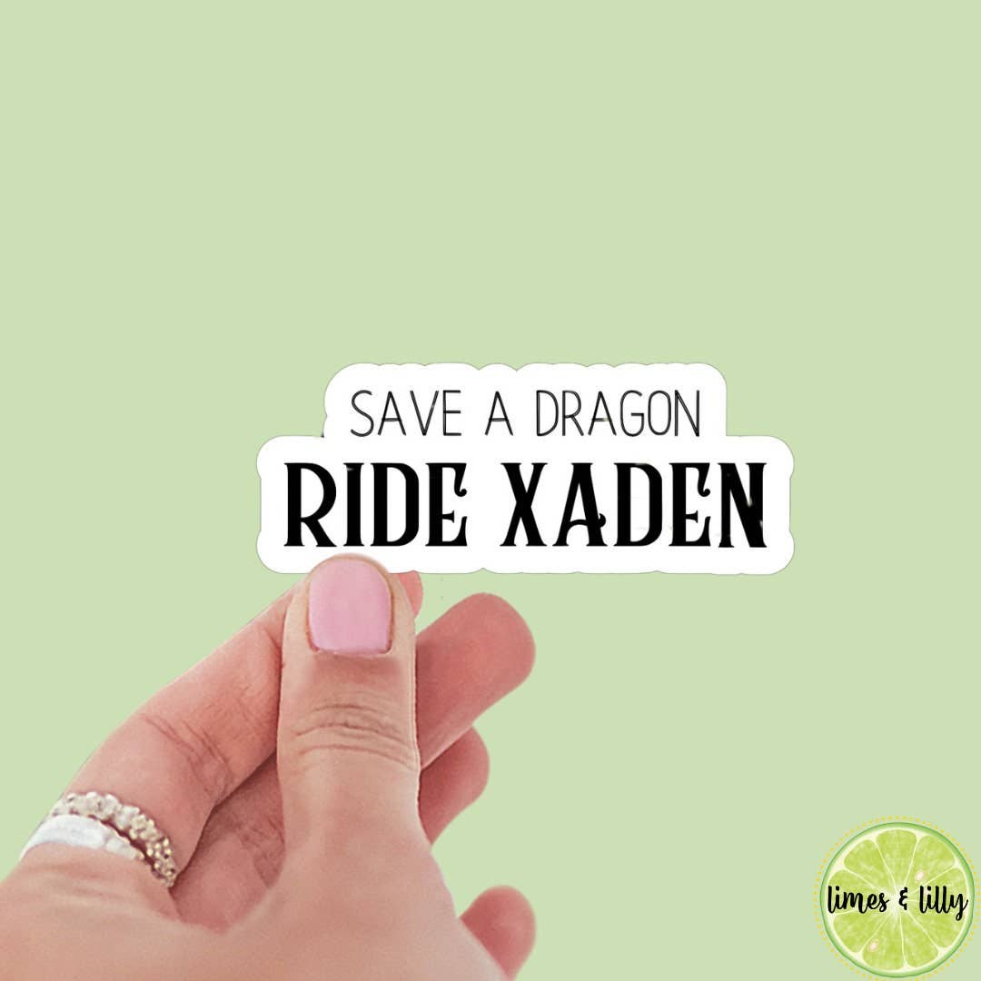 Hand holding a sticker with &