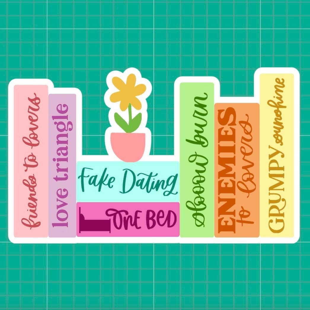 Set of colorful bookends with text and a flower design on a green grid background