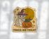 A die-cut sticker featuring a cute white kitten in a witch hat next to a carved orange pumpkin, with the words &