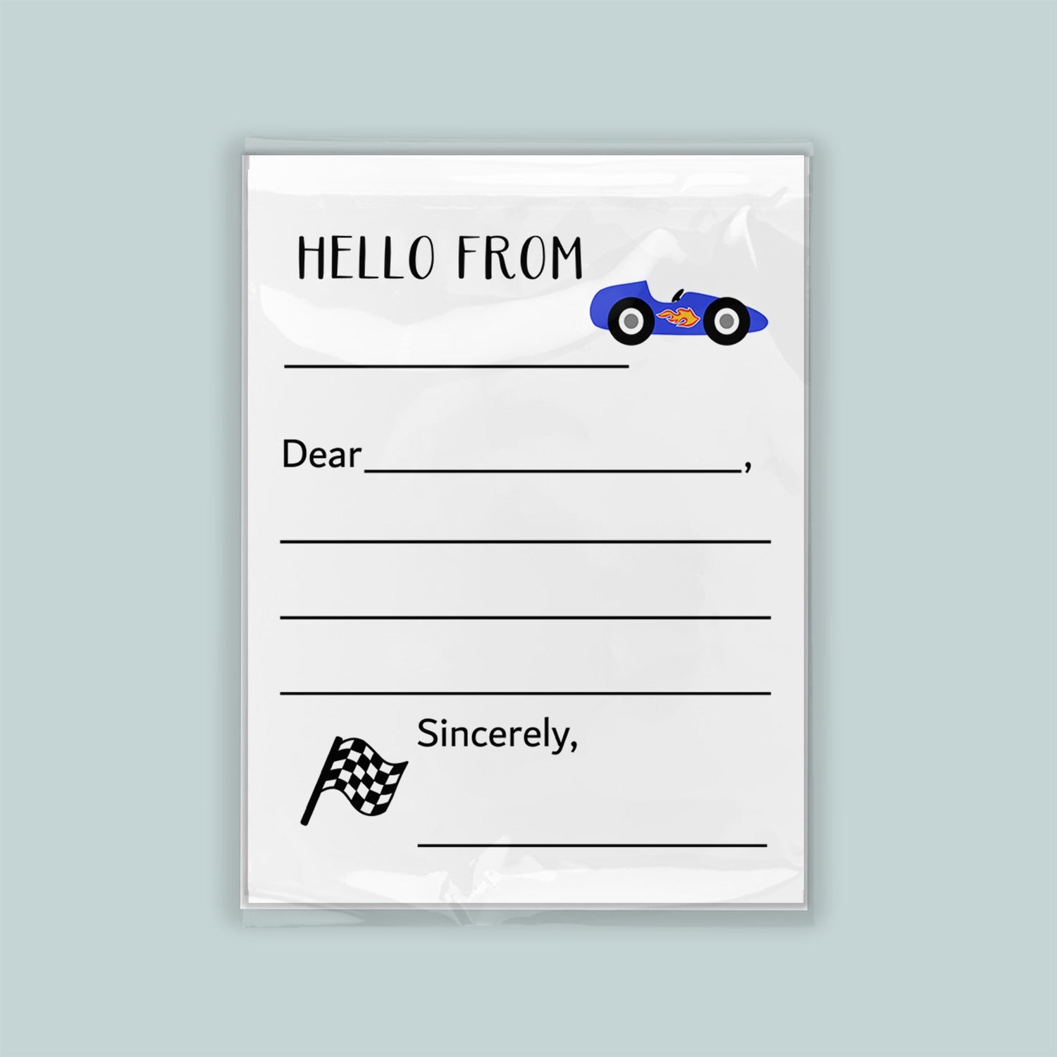 The image is a white envelope with a blue car illustration on the front. The envelope has a blank space for a message and a checkered flag symbol.