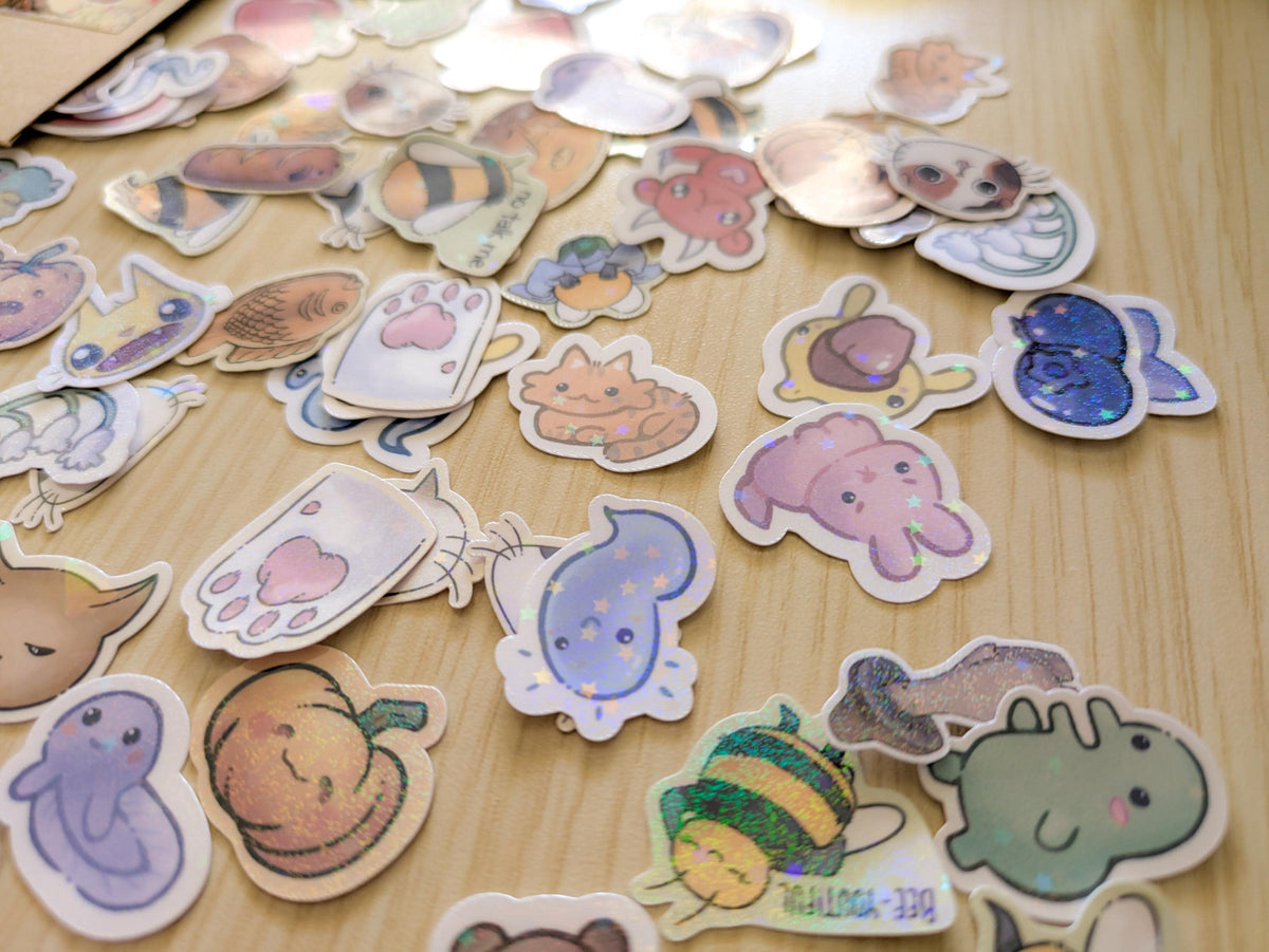 Collection of colorful cartoon-style stickers on a wooden surface