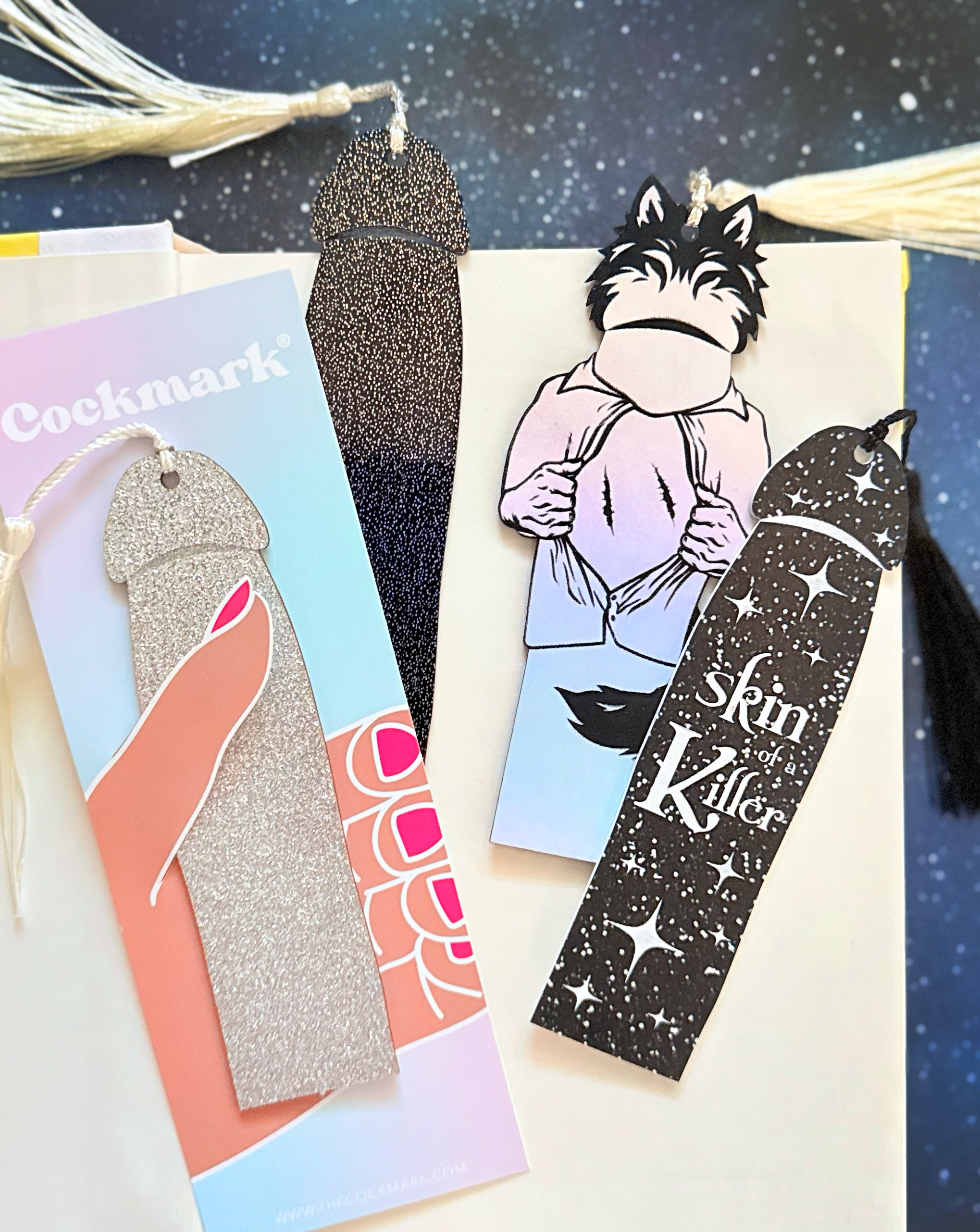 Collection of unique bookmarks with various designs and text on a starry background.