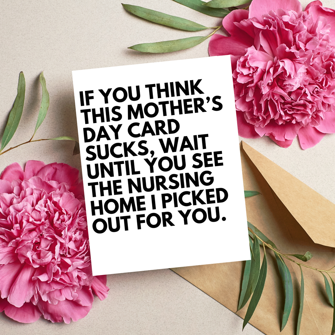 Card with humorous text surrounded by pink flowers and green leaves on a beige background