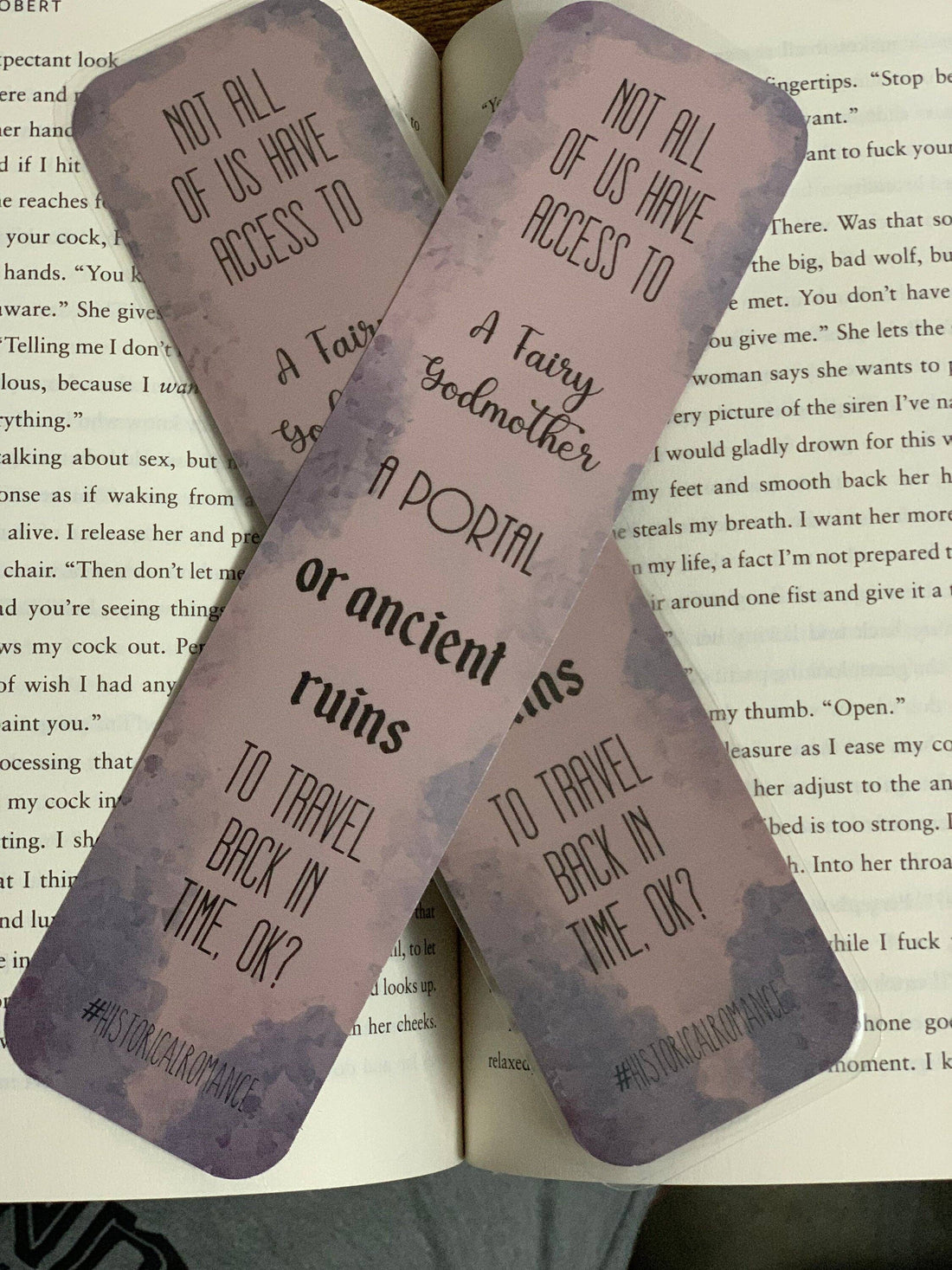 Two pink bookmarks with text on an open book