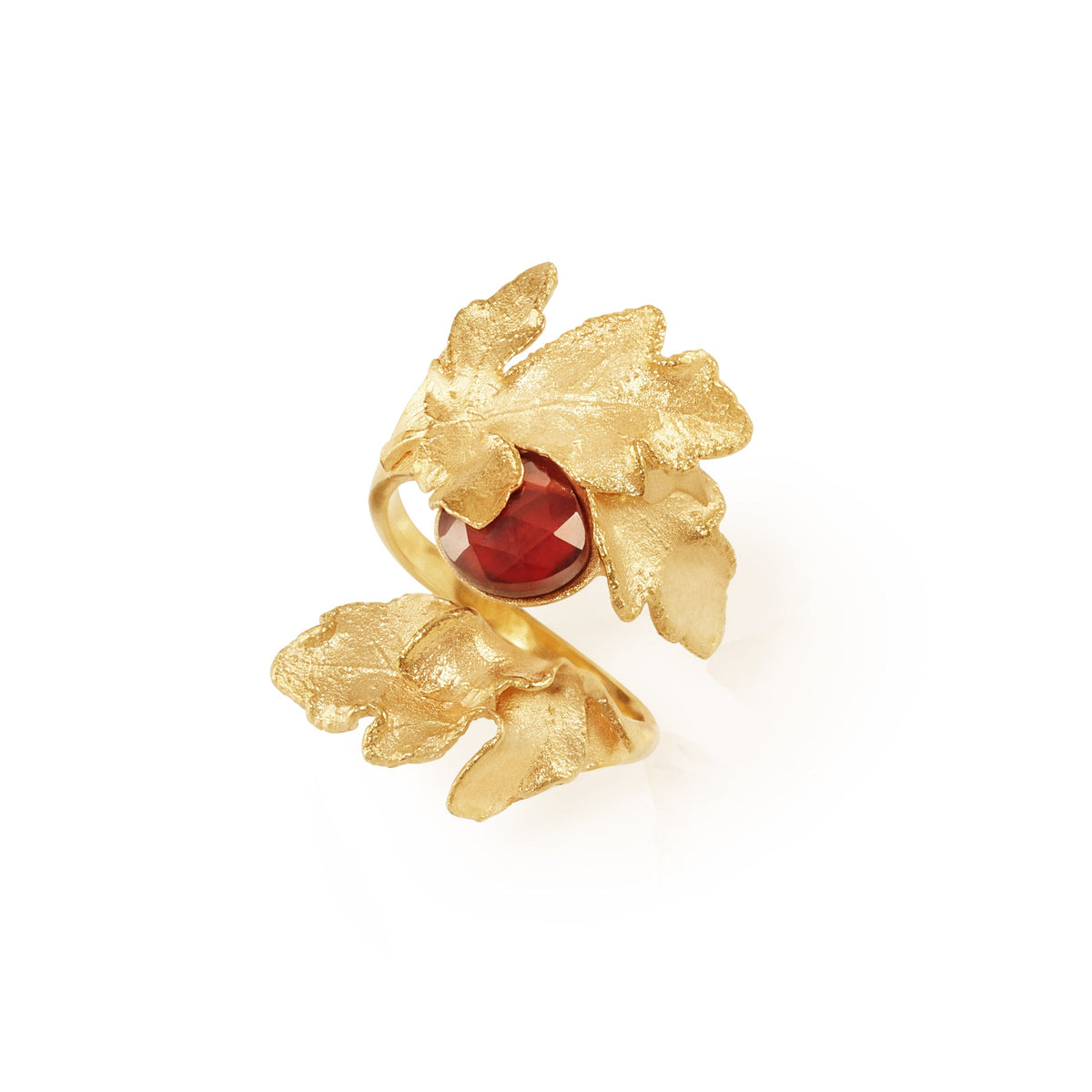gold handcrafted wrap leaf ring with january birthstone garnet, flat lay