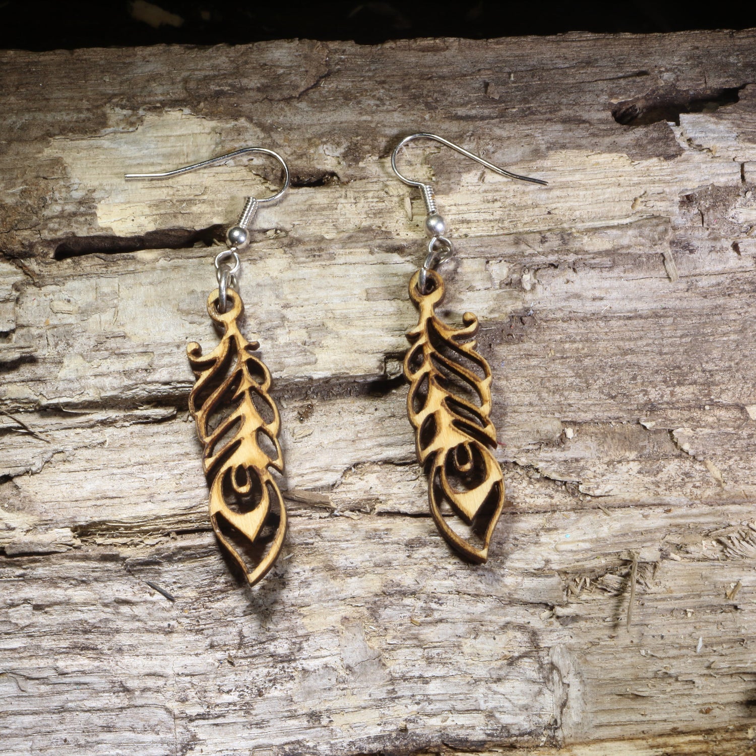 Handcrafted Art Nouveau feather wooden dangle earrings featuring an elegant openwork feather design with flowing lines. Lightweight nature-inspired earrings with hypoallergenic .925 sterling silver hooks, perfect for boho fashion, free spirits, bird lovers, artistic jewelry collections, and everyday handmade accessories.