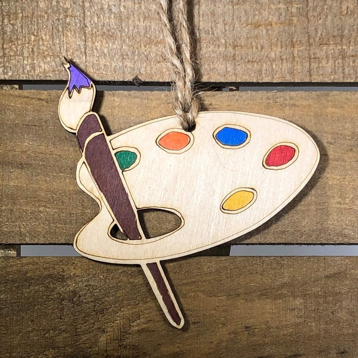 Hand-painted wooden artist Christmas ornament featuring creative art-themed details like paintbrush and palette design, unique holiday decor gift for artists and creative enthusiasts by Cate’s Concepts