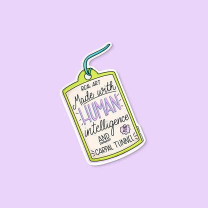 Art Made With Human Intelligence sticker flat lay — human artist activist sticker by MangoIllustrated