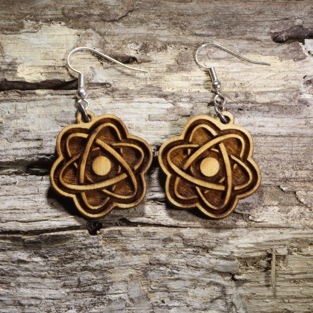 Handcrafted atom wooden dangle earrings featuring a classic atomic model with orbiting electrons. Lightweight laser-cut wooden earrings with hypoallergenic .925 sterling silver hooks, perfect for scientists, chemistry teachers, physics students, STEM enthusiasts, laboratory professionals, and science lovers.