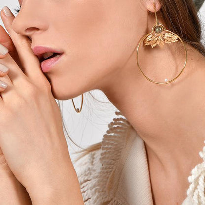 artisan hand crafted gold hoop leaf earrings, on model