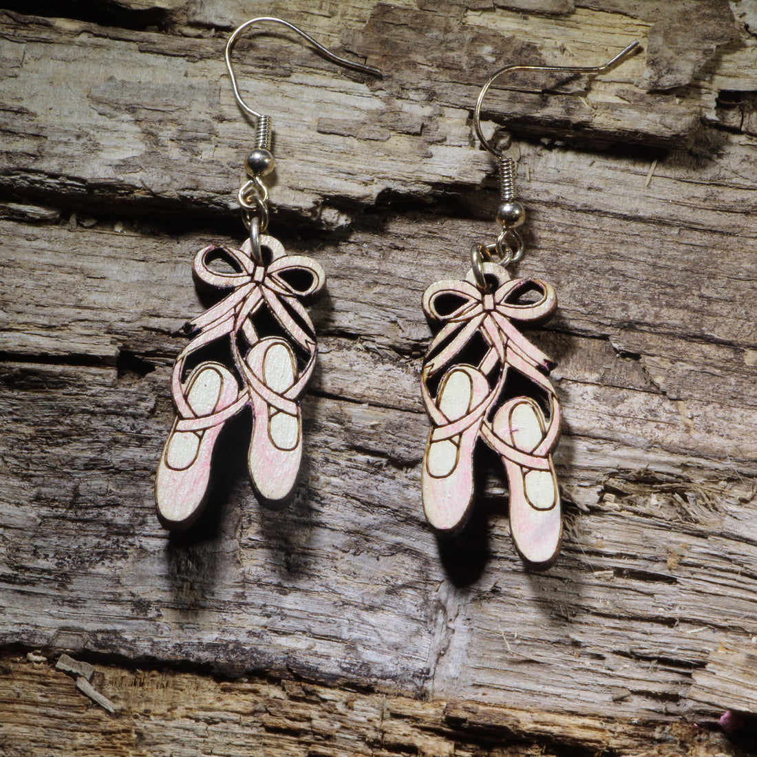 Hand-painted wooden ballet shoes dangle earrings on hypoallergenic .925 sterling silver hooks. Lightweight dance jewelry for ballet dancers, dance teachers, recital gifts, and performing arts enthusiasts.