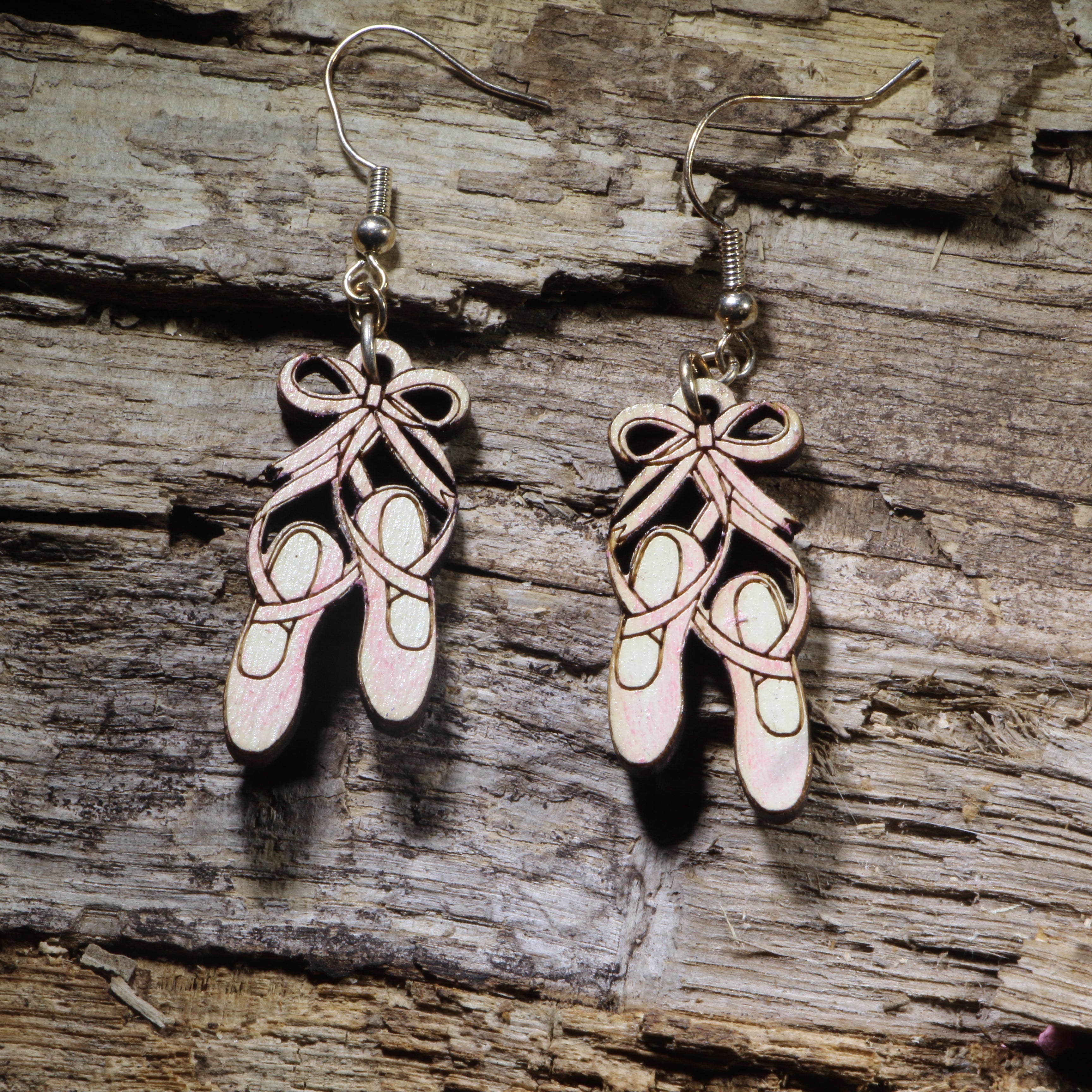 Hand-painted wooden ballet shoes dangle earrings on hypoallergenic .925 sterling silver hooks. Lightweight dance jewelry for ballet dancers, dance teachers, recital gifts, and performing arts enthusiasts.