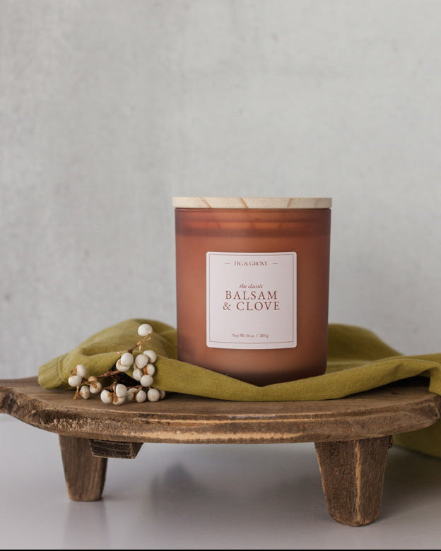 Balsam &amp; Clove candle in brown glass jar with white berries evoking fresh mountain air and warm spice – Fig &amp; Grove