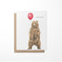 Greeting card with a bear holding a red balloon and &
