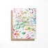 A colorful watercolor painting on a greeting card with a quote about beauty in moments.