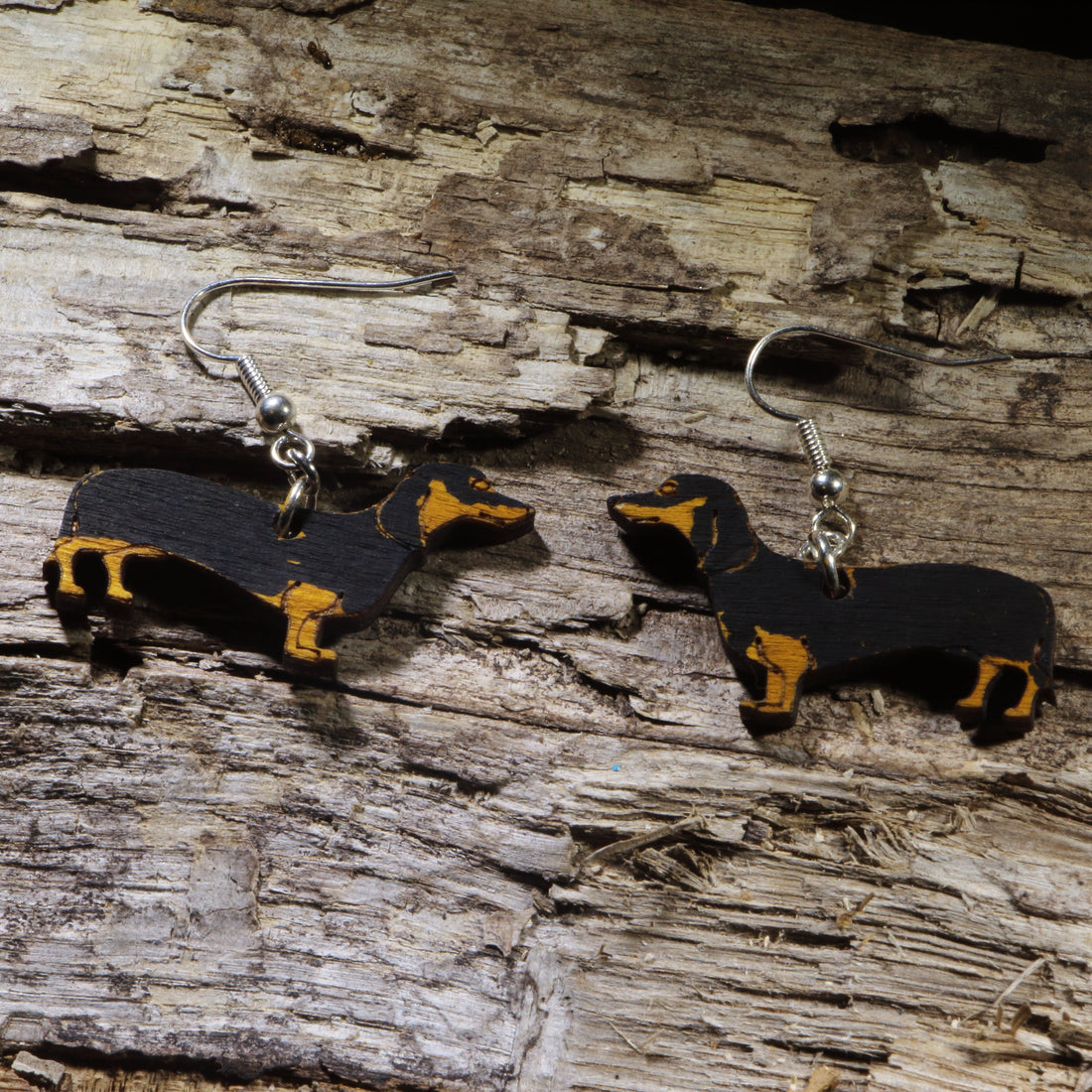 Hand-painted black and tan Dachshund wooden dangle earrings on hypoallergenic .925 sterling silver hooks. Lightweight Wiener dog jewelry for Dachshund owners, dog lovers, pet parents, and breed enthusiasts.