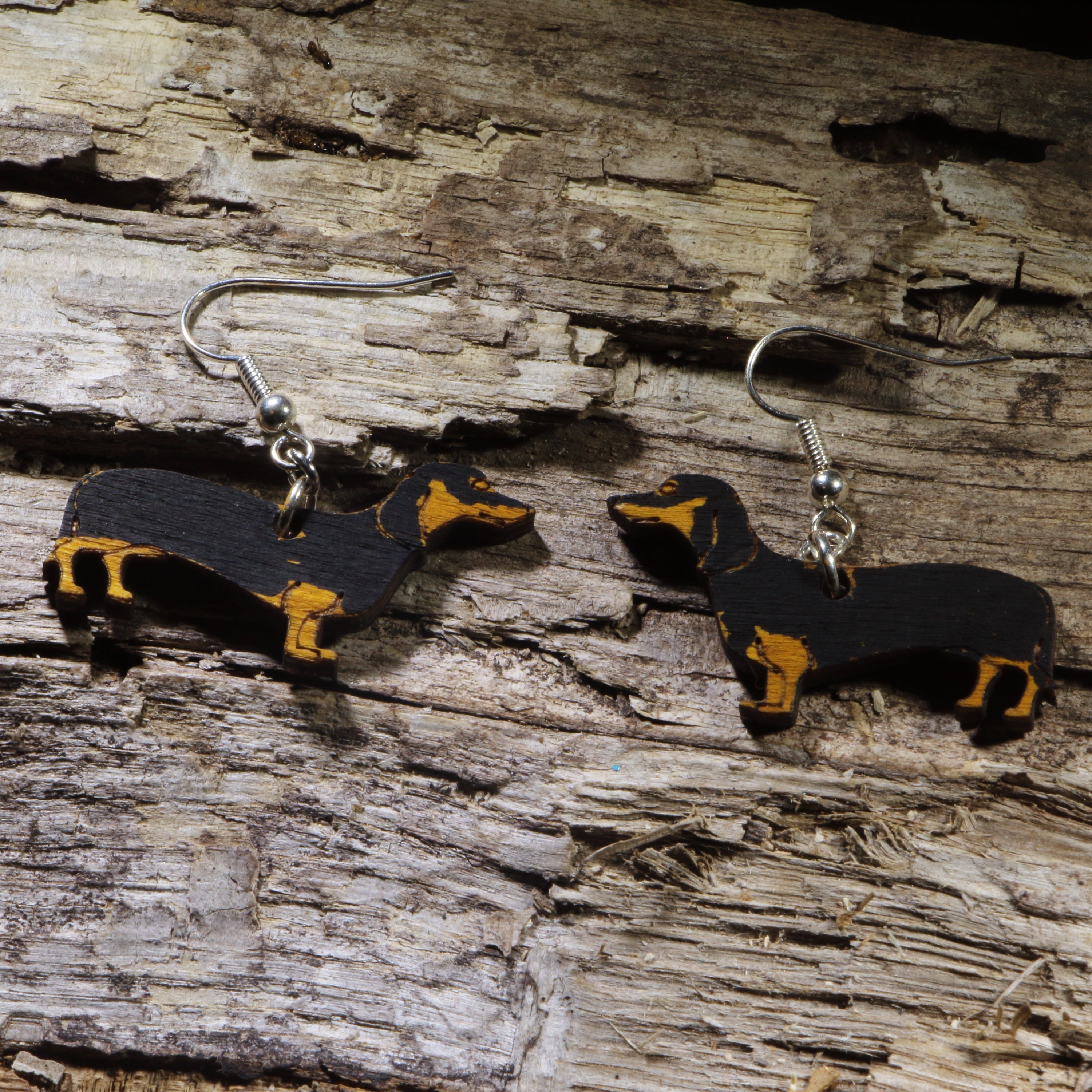 Hand-painted black and tan Dachshund wooden dangle earrings on hypoallergenic .925 sterling silver hooks. Lightweight Wiener dog jewelry for Dachshund owners, dog lovers, pet parents, and breed enthusiasts.