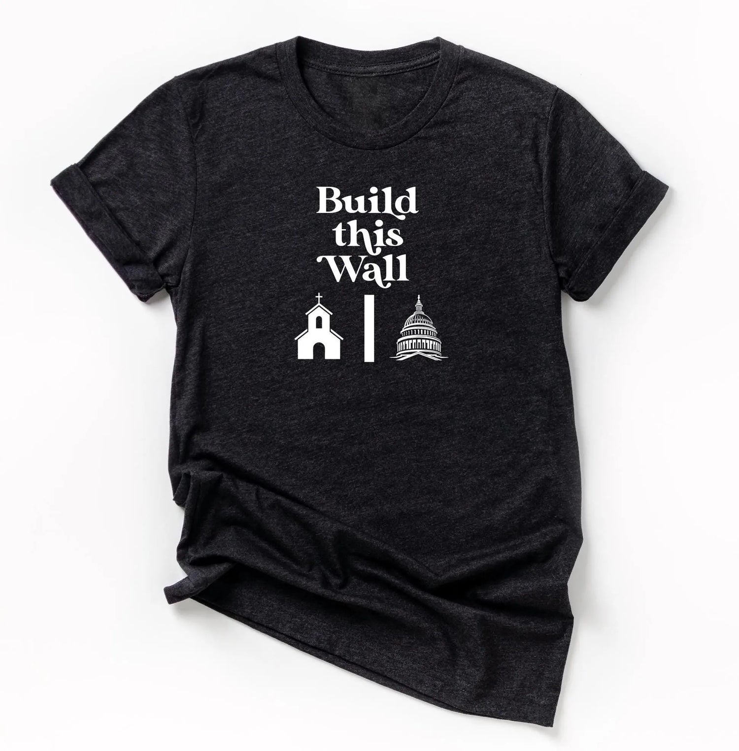build this wall shirt.  black short sleeve shirt with white modern retro font and graphics of church being separated by wall and capital government building on other side.  snarky atheist shirt making fun of trump&amp;