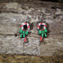 Hand-painted wooden candy cane with bow dangle earrings featuring festive red and white candy canes accented with a holiday bow, hypoallergenic sterling silver hooks, and lightweight Christmas jewelry for holiday celebrations by Cate&