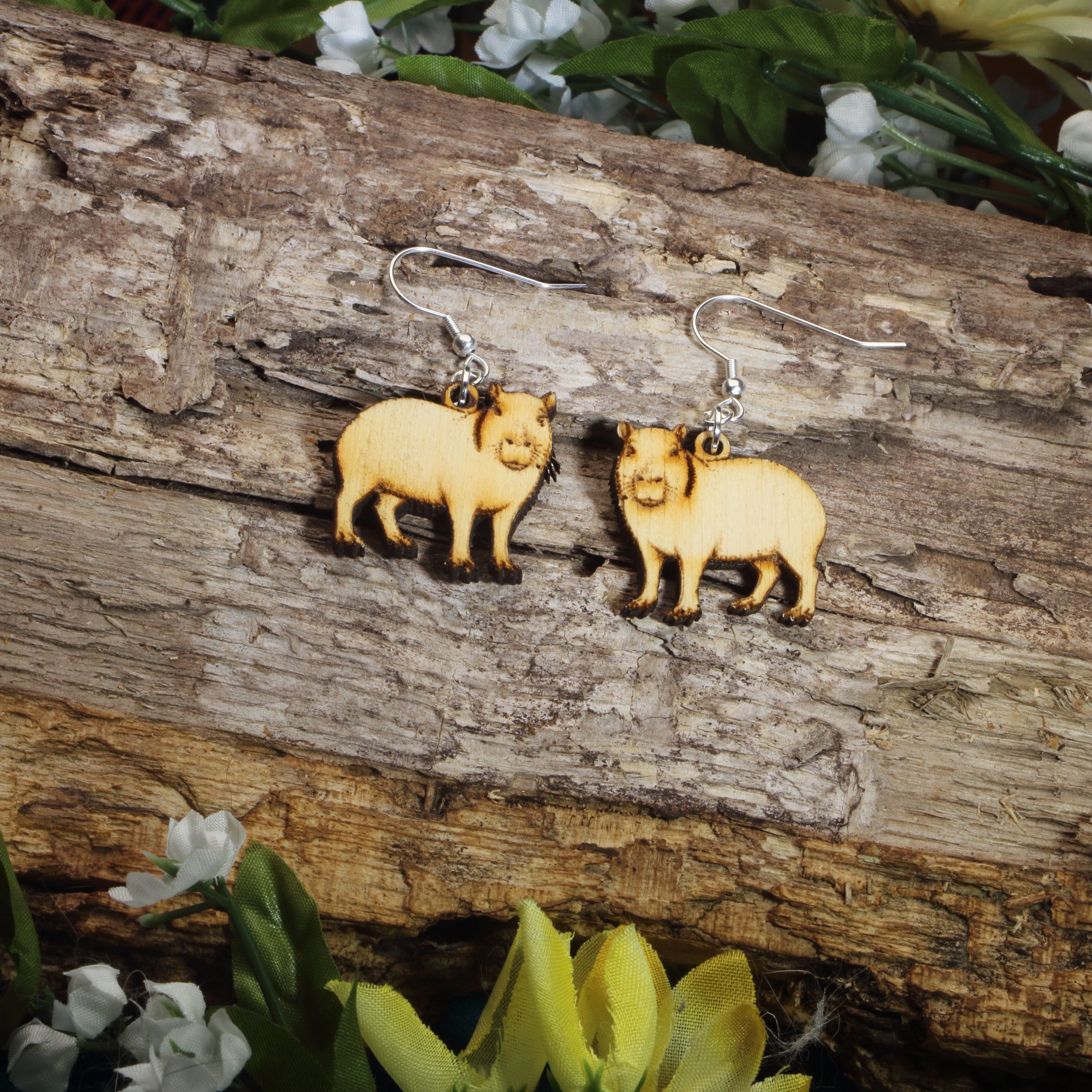 Hand-painted wooden capybara dangle earrings featuring an adorable capybara animal design, hypoallergenic sterling silver hooks, and lightweight wildlife jewelry for rodent lovers, animal enthusiasts, and cute everyday style by Cate’s Concepts.