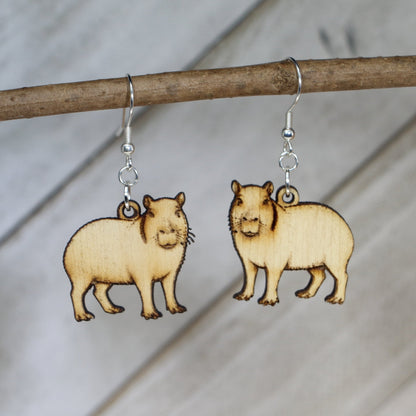 Hand-painted wooden capybara dangle earrings with cute animal design and hypoallergenic sterling silver hooks, lightweight wildlife jewelry for animal lovers and playful style by Cate’s Concepts

