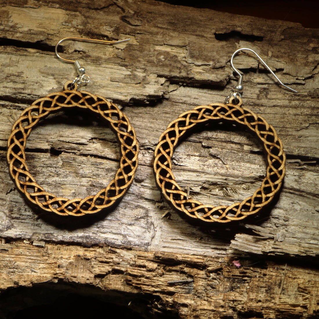 Hand-painted wooden Celtic knot hoop dangle earrings featuring an intricate interwoven Celtic knot design symbolizing eternity, unity, and heritage. Crafted from lightweight wood with hypoallergenic .925 sterling silver hooks, these artisan earrings are perfect for Celtic heritage, Irish and Scottish pride, Renaissance fairs, St. Patrick&