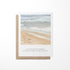 A greeting card with a watercolor painting of a coastal beach and a quote