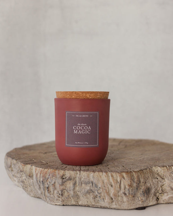 Cocoa Magic candle in umber glass jar on neutral background, evoking cocoa and coffee tones – Fig &amp; Grove