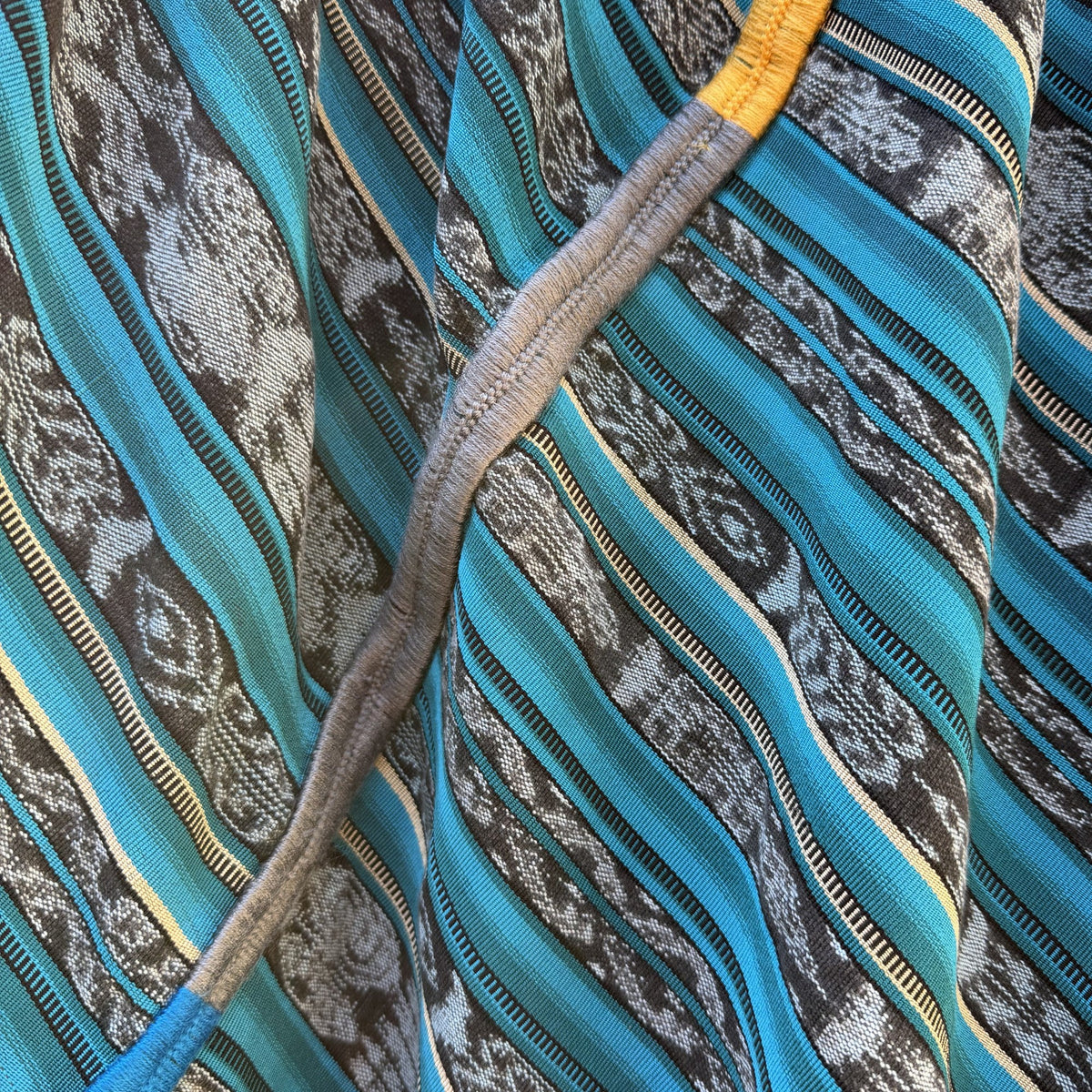 Close-up of a textured fabric with blue, gray, and yellow patterns