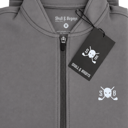 Close-up of a gray zip-up hoodie with a black hangtag and white printed Skull &amp; Bageys branding, including a skull-and-crossbones logo on the chest.