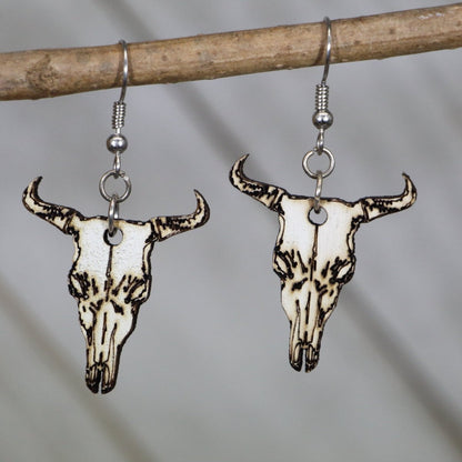 Hand-painted wooden cow skull dangle earrings with western boho desert design and hypoallergenic sterling silver hooks, lightweight cow skull statement jewelry earrings for southwestern style