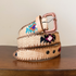 Woven belt with floral patterns on a wooden surface
