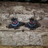 Hand-painted wooden cute Mothman dangle earrings featuring an adorable winged cryptid with glowing red eyes, hypoallergenic sterling silver hooks, and lightweight cryptid mythology jewelry for folklore fans and paranormal enthusiasts by Cate&