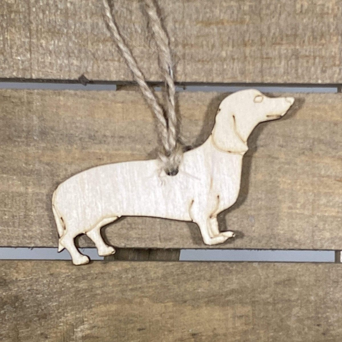 Hand-painted wooden dachshund Christmas ornament featuring a long-bodied wiener dog design with playful details and smooth silhouette, festive holiday decor for dog lovers and dachshund enthusiasts by Cate’s Concepts