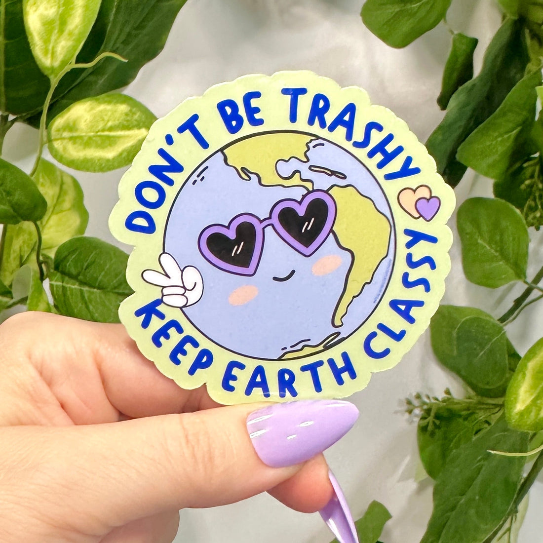 Sticker with Earth design with purple heart sunglasses and peace fingers with wrapped circular text &