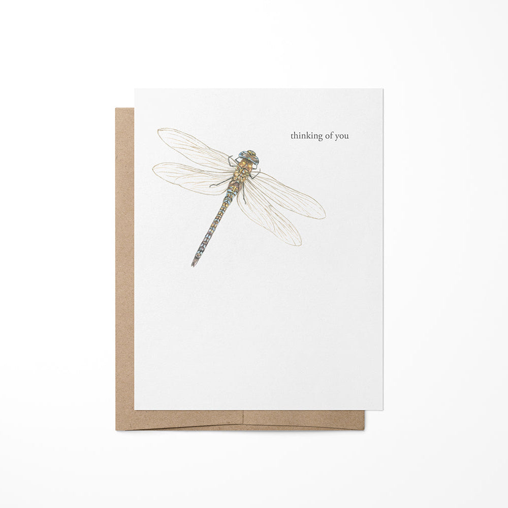 A greeting card with a dragonfly illustration, placed on a white background.