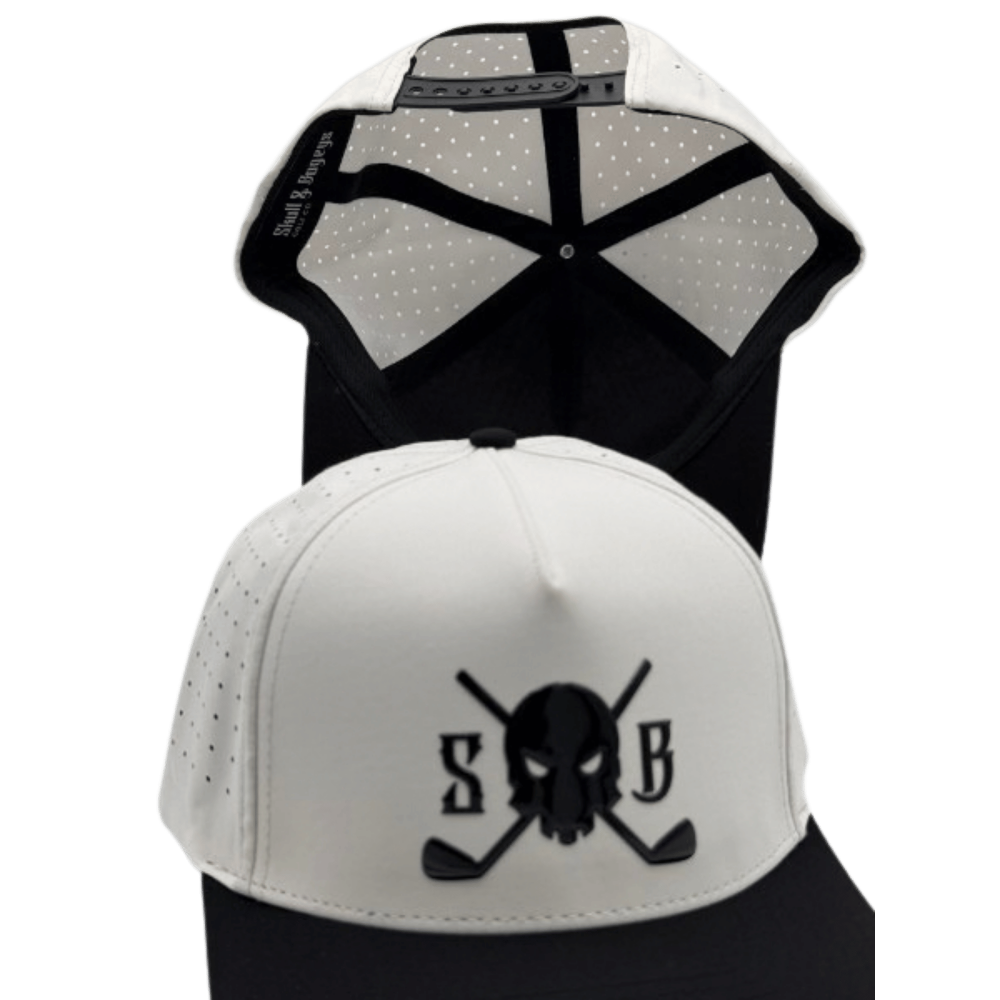 A white and black trucker-style cap shown from the front and back. The front features a black embroidered skull and crossed golf clubs design with the letters &
