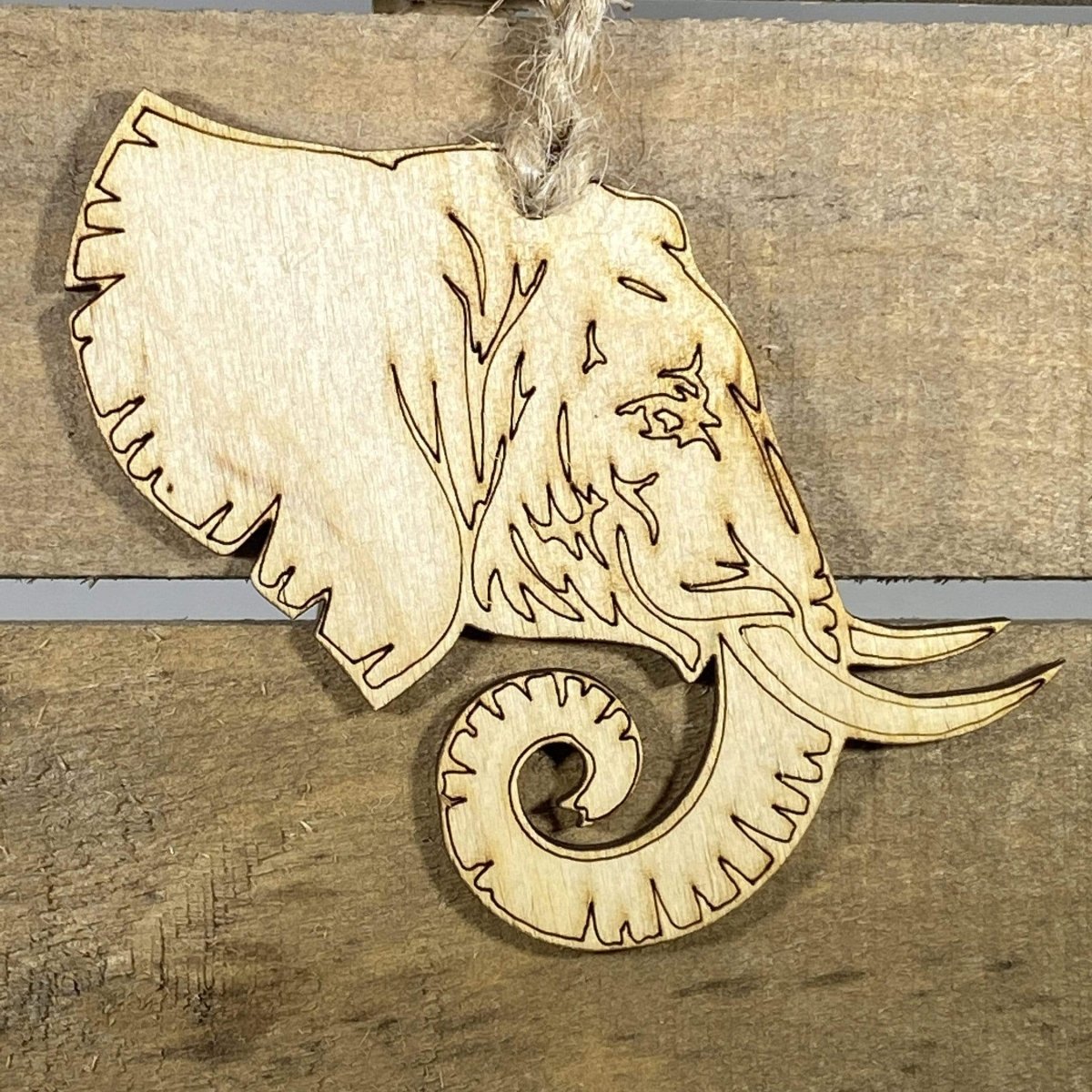 Hand-painted wooden elephant profile Christmas ornament featuring a detailed safari animal silhouette with curved trunk and tusk design, unique holiday decor for wildlife lovers and animal enthusiasts by Cate’s Concepts