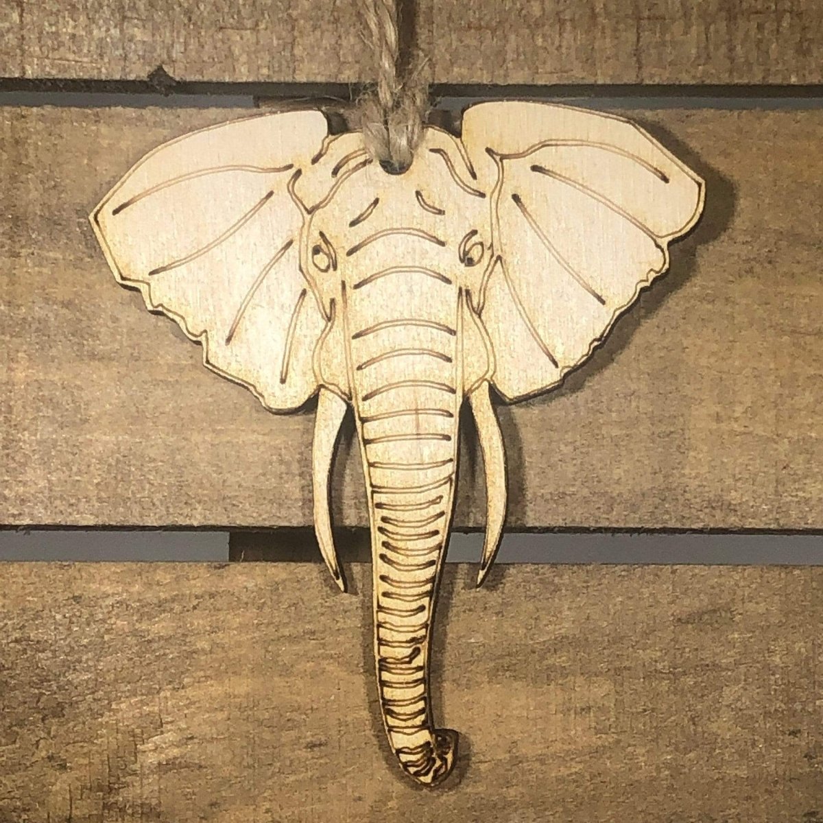 Hand-painted wooden elephant Christmas ornament featuring a detailed animal design with curved trunk and classic safari-inspired style, unique holiday decor for animal lovers and wildlife enthusiasts by Cate’s Concepts