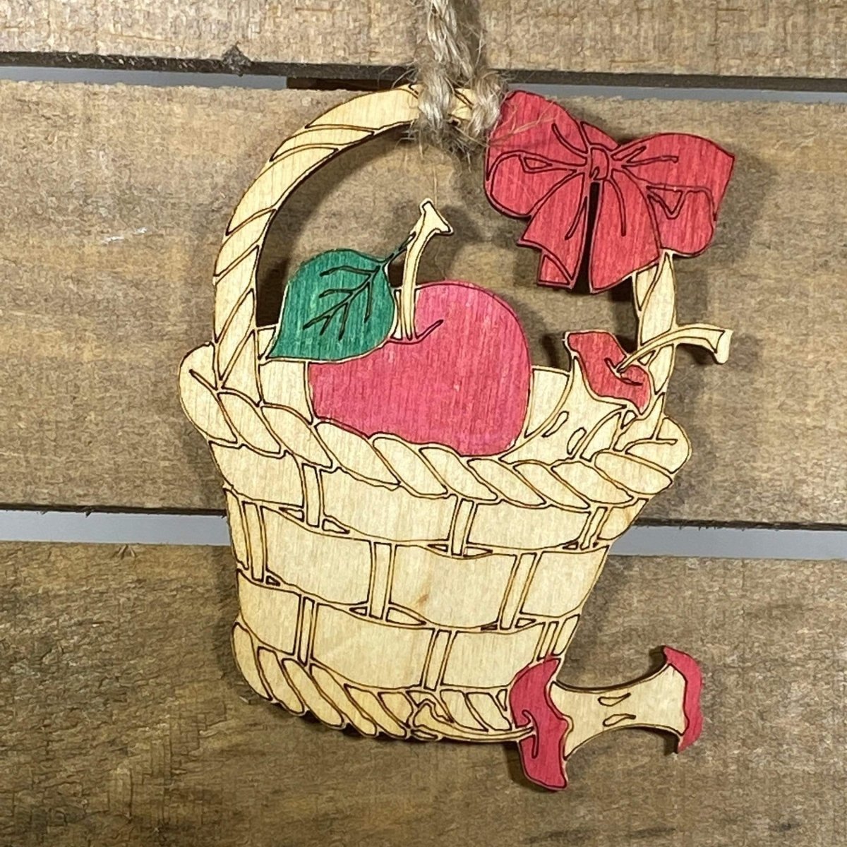 Hand-painted wooden farmhouse apple Christmas ornament featuring a rustic red apple design with natural detailing and country charm, cozy holiday decor for farmhouse kitchens and rustic home lovers by Cate’s Concepts