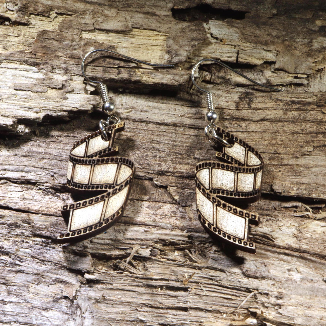 Hand-painted wooden film strip dangle earrings featuring a classic movie reel design. Lightweight cinema-inspired earrings with hypoallergenic .925 sterling silver hooks, perfect for filmmakers, movie lovers, film students, photographers, theater enthusiasts, and anyone passionate about the art of storytelling.