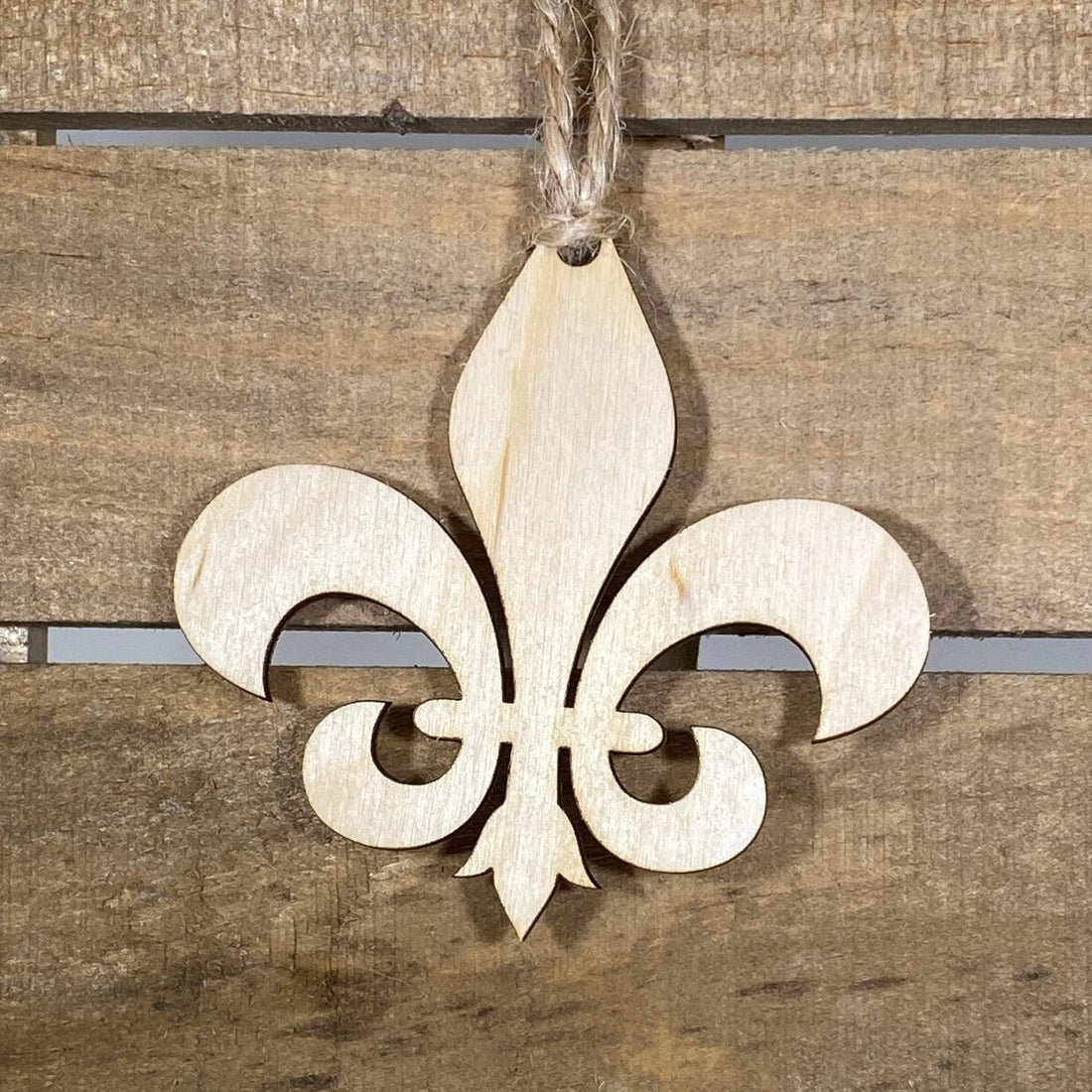 Hand-painted wooden fleur-de-lis Christmas ornament featuring an elegant classic symbol with refined symmetrical design, timeless holiday decor for French heritage lovers and traditional style enthusiasts by Cate’s Concepts