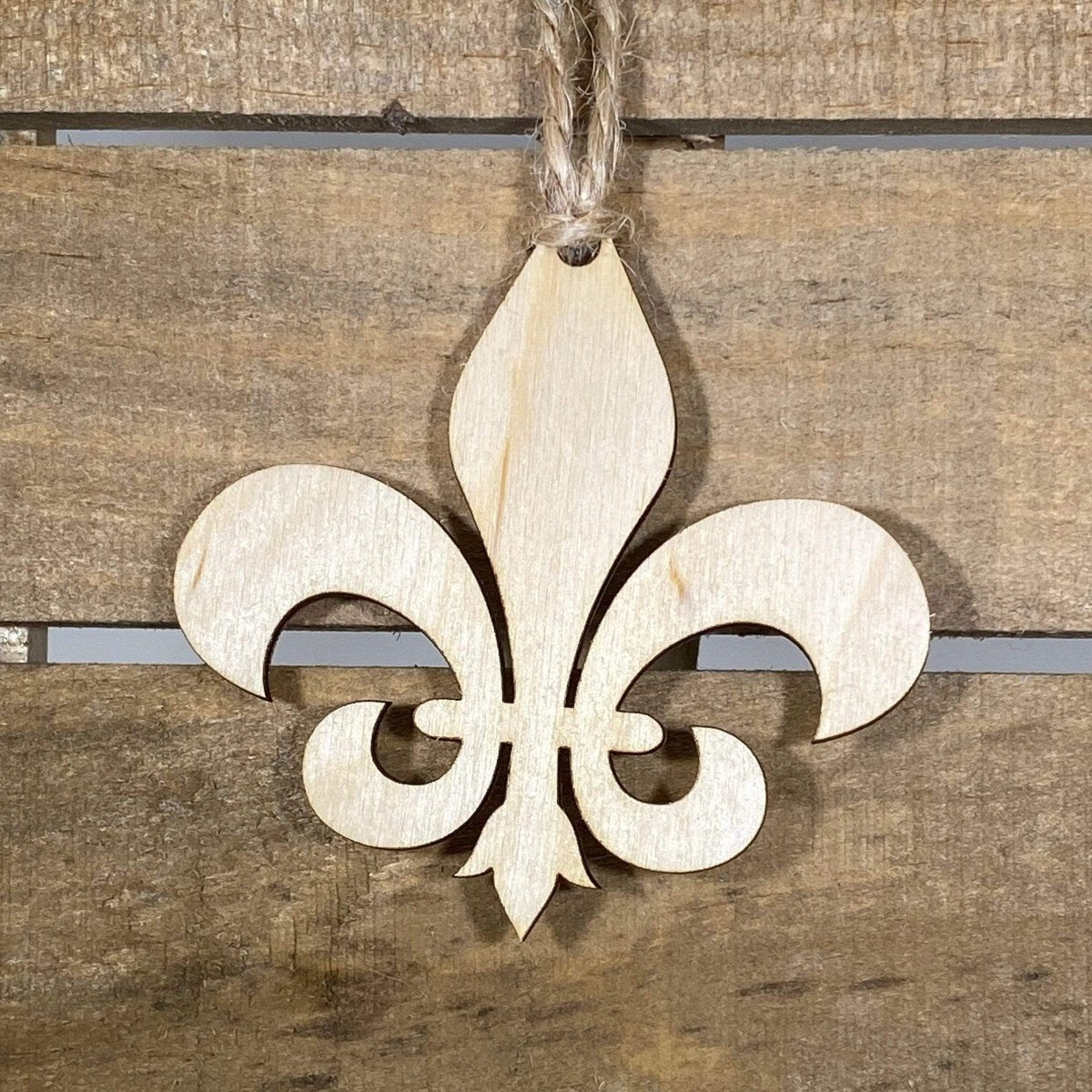 Hand-painted wooden fleur-de-lis Christmas ornament featuring an elegant classic symbol with refined symmetrical design, timeless holiday decor for French heritage lovers and traditional style enthusiasts by Cate’s Concepts