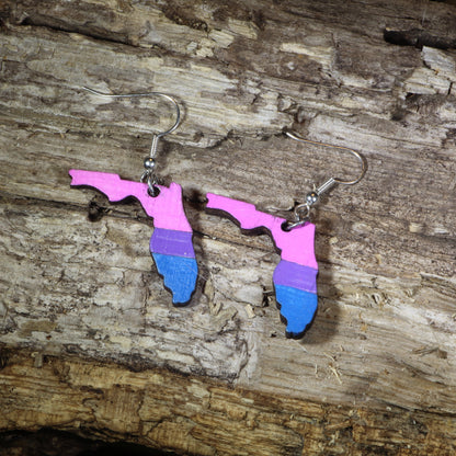 Hand-painted wooden Florida bisexual pride dangle earrings featuring the Florida state silhouette in pink, purple, and blue bisexual pride stripes, hypoallergenic sterling silver hooks, and lightweight LGBTQ+ state pride jewelry by Cate&