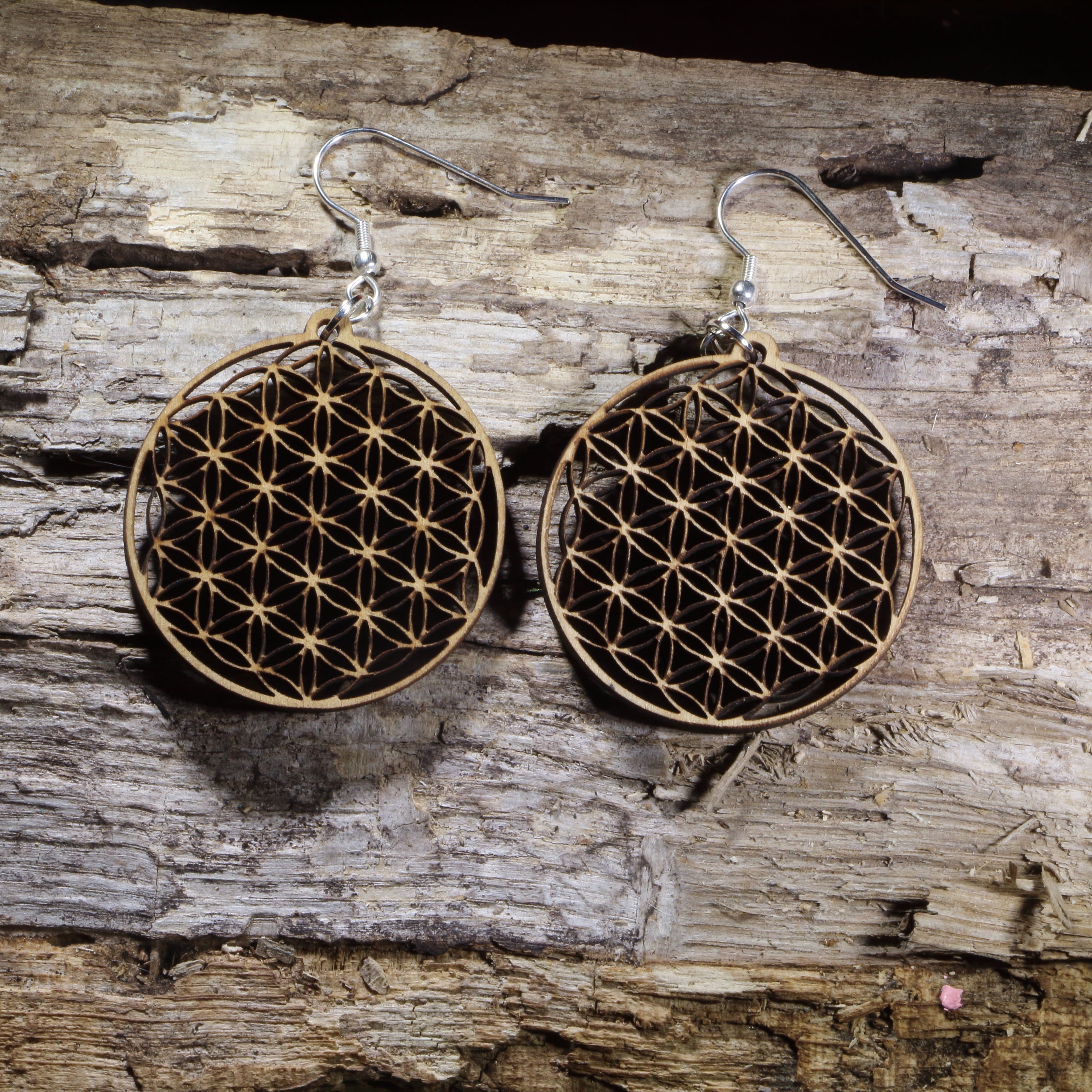 Handcrafted Flower of Life wooden dangle earrings featuring the sacred geometry symbol representing harmony, unity, and the interconnectedness of all life. Lightweight laser-cut wooden earrings with hypoallergenic .925 sterling silver hooks, perfect for yoga enthusiasts, meditation practitioners, spiritual jewelry lovers, reiki healers, and fans of sacred geometry.