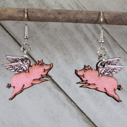 Hand-painted wooden flying pig dangle earrings with whimsical realistic pig design and hypoallergenic sterling silver hooks, quirky farm animal statement jewelry earrings