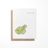 Greeting card featuring a watercolor illustration of a green frog on a white background