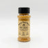 A bottle of Rainey Dog Ranch Fry Dust seasoning with a black cap and beige label, filled with a golden-brown spice blend, set against a clean white background.