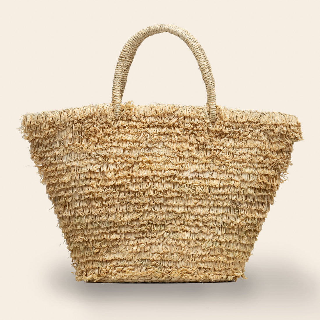 Natural Woven straw bag with a loop textured surface handmade in Rwanda through a fair trade partnership