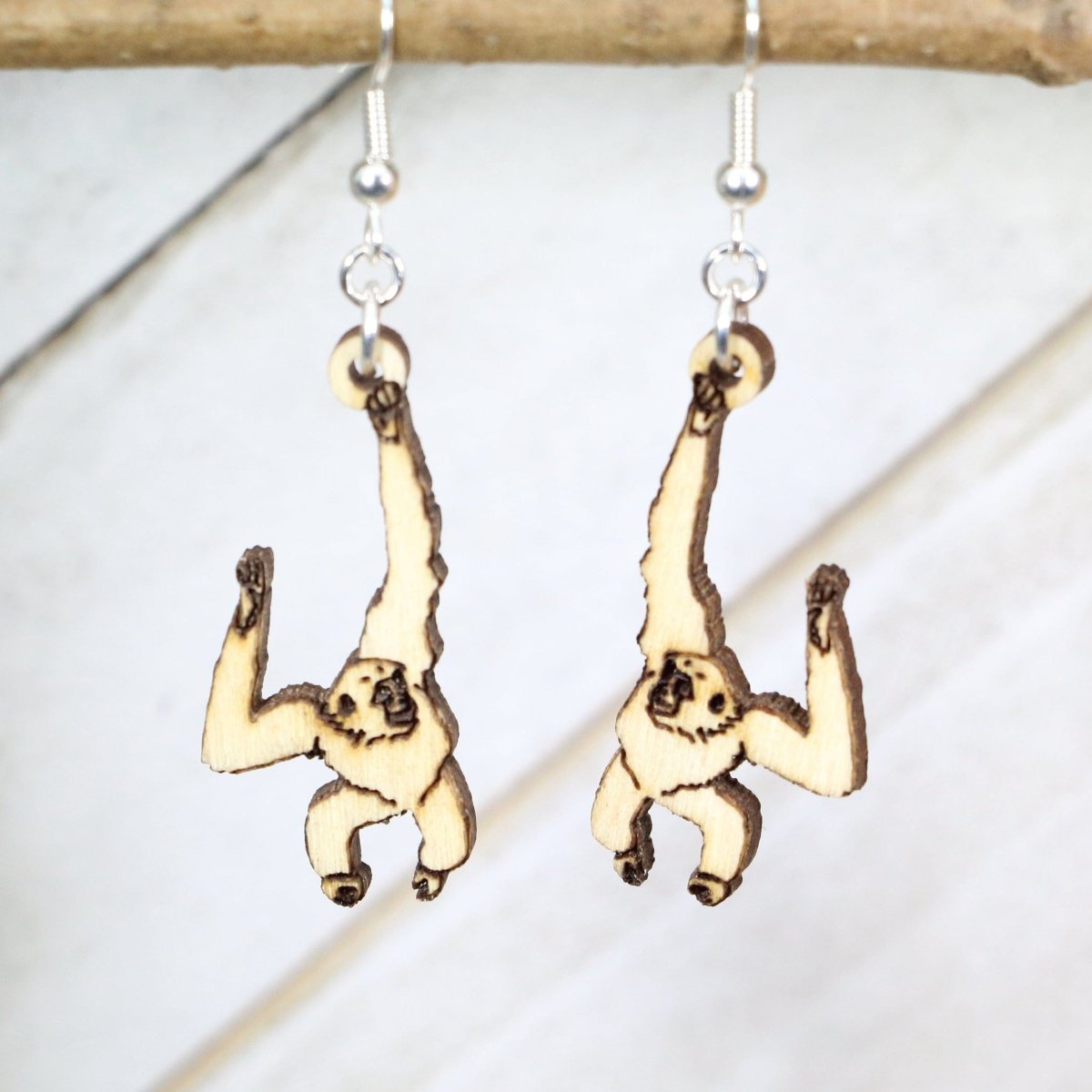 Hand-painted wooden gibbon dangle earrings with detailed primate wildlife design and hypoallergenic sterling silver hooks, animal lover statement jewelry for zoo fans and nature enthusiasts
